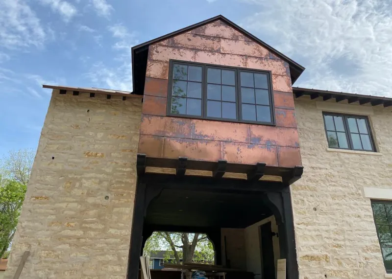 Copper metal panel facade on a stone building for Roof Repair in Davis